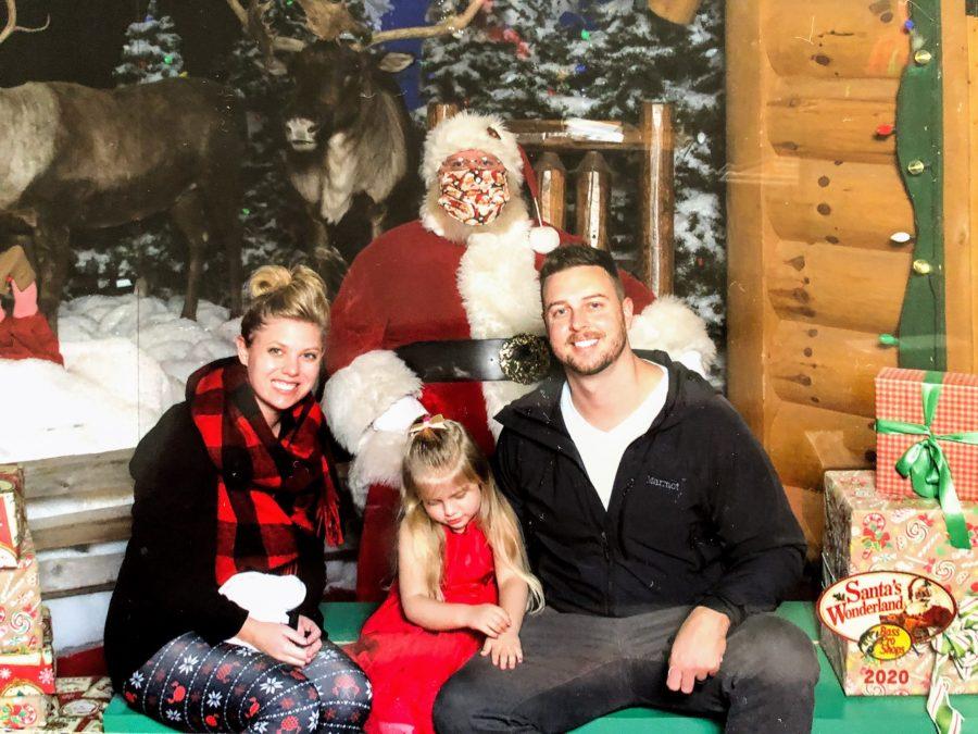 Sarah Rhine, her husband Kyle Rhine, and their daughter Emma Rhine got their picture with Santa Claus at Bass Pro Shop.
